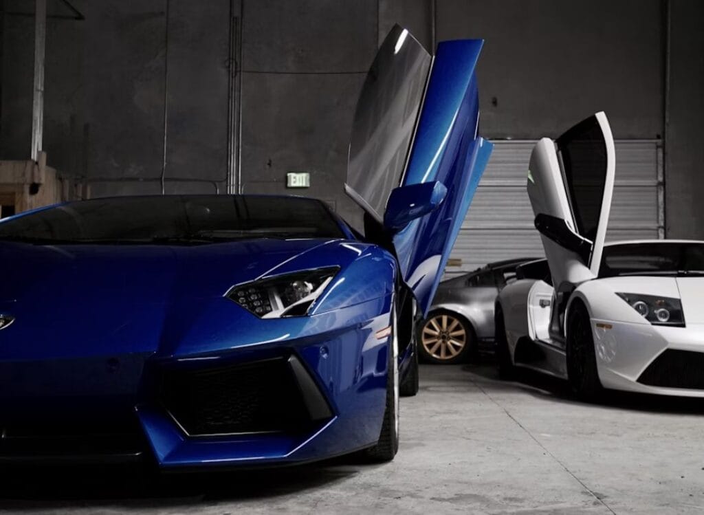 two white and blue Lamborghini vehicles inside garage